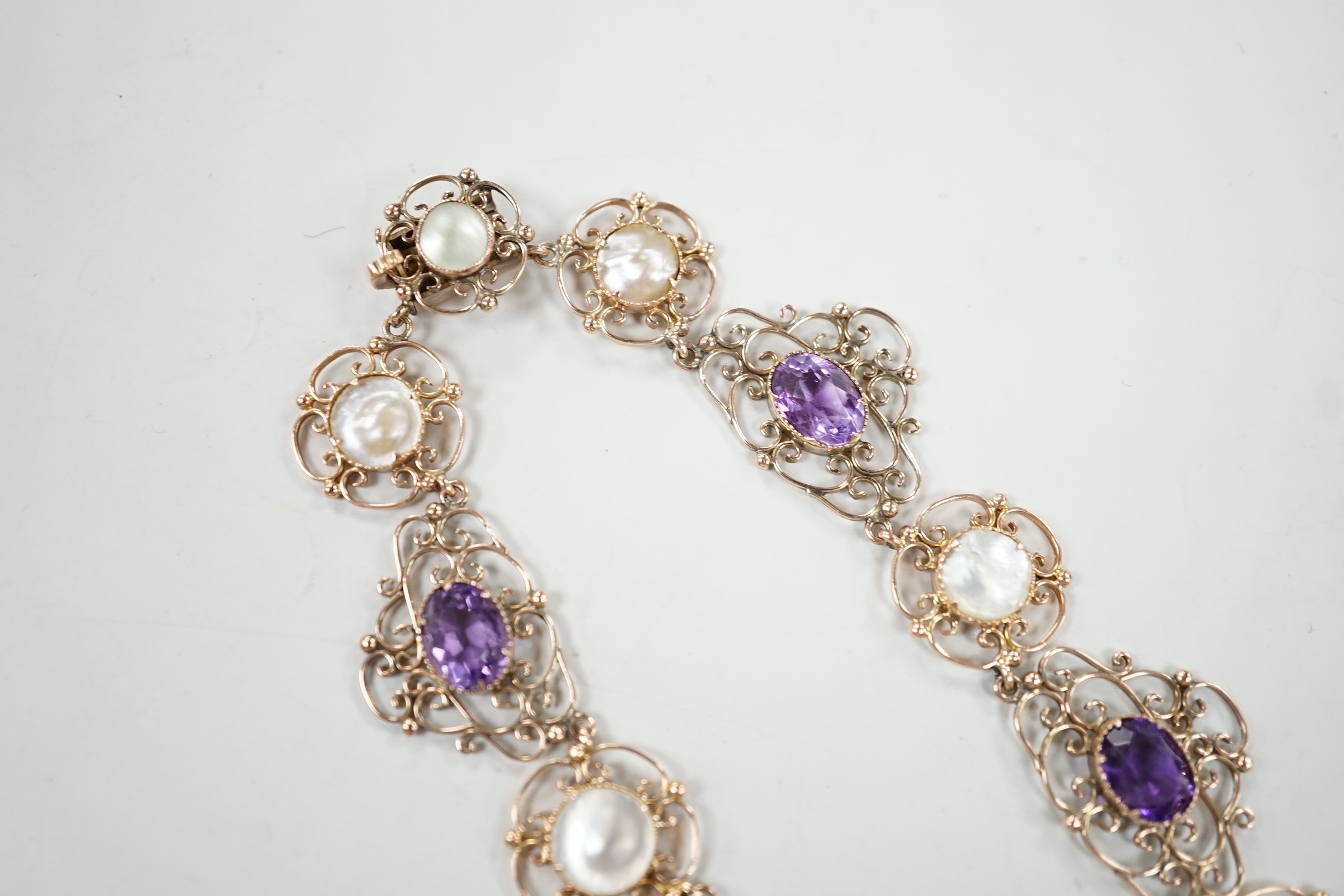 An Edwardian yellow metal, amethyst and mother-of-pearl set drop necklace, 44cm, gross weight 29.5 grams.